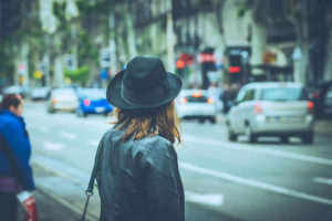 Photo of a woman in a city about to cross a busy street. Unresolved trauma can affect your life daily. Learn with a trauma therapist in California how you can begin to manage your trauma.