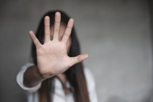 Photo of a woman holding out her hand blocking her face. This photo represents how you can stop your depression symptoms in their tracks with depression therapy in California. Learn more here.