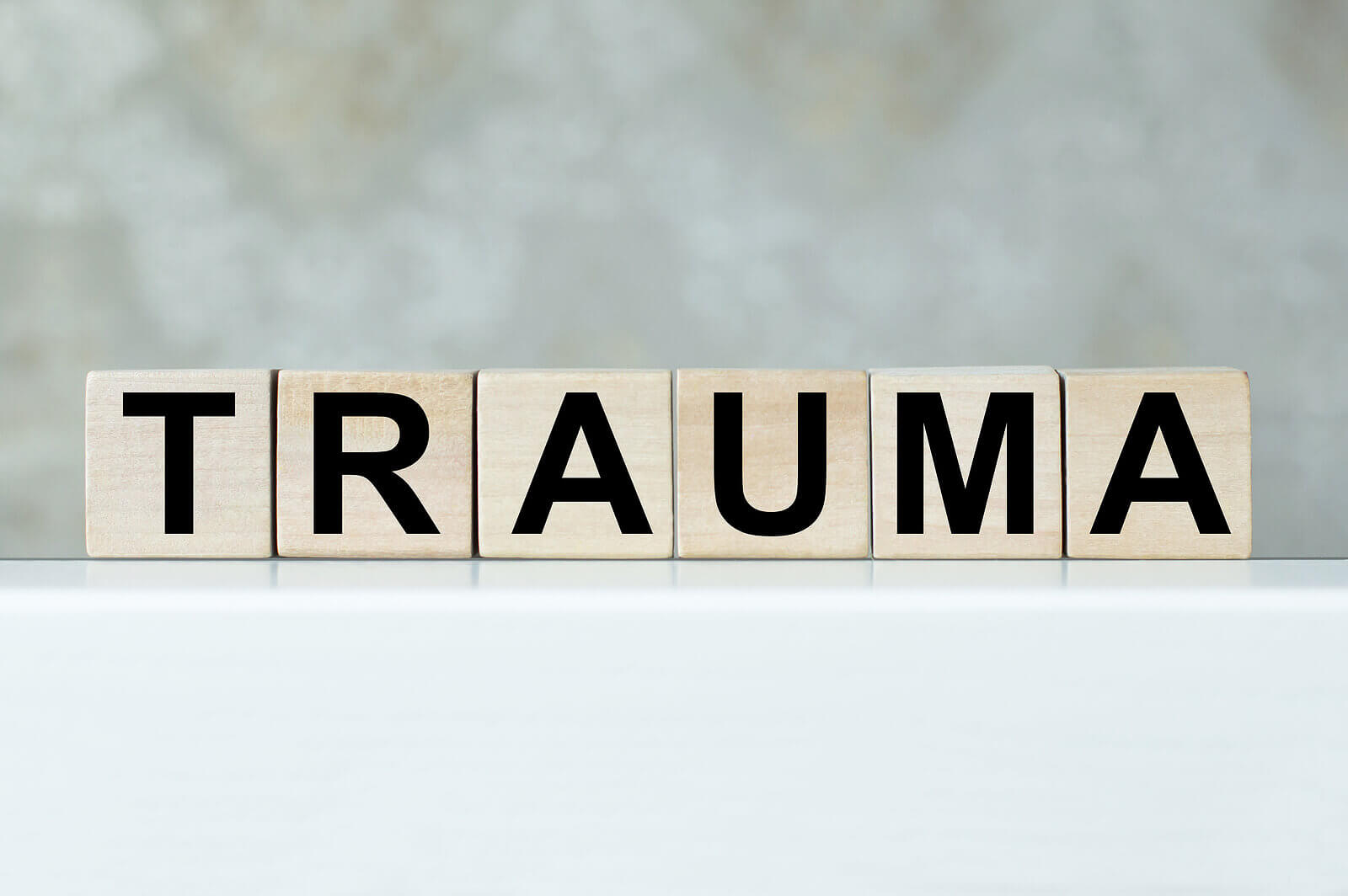 Photo os blocks that spell out the word trauma. Are you struggling with unresolved trauma? Learn how you can cope with a trauma therapist in San Ramon, CA.