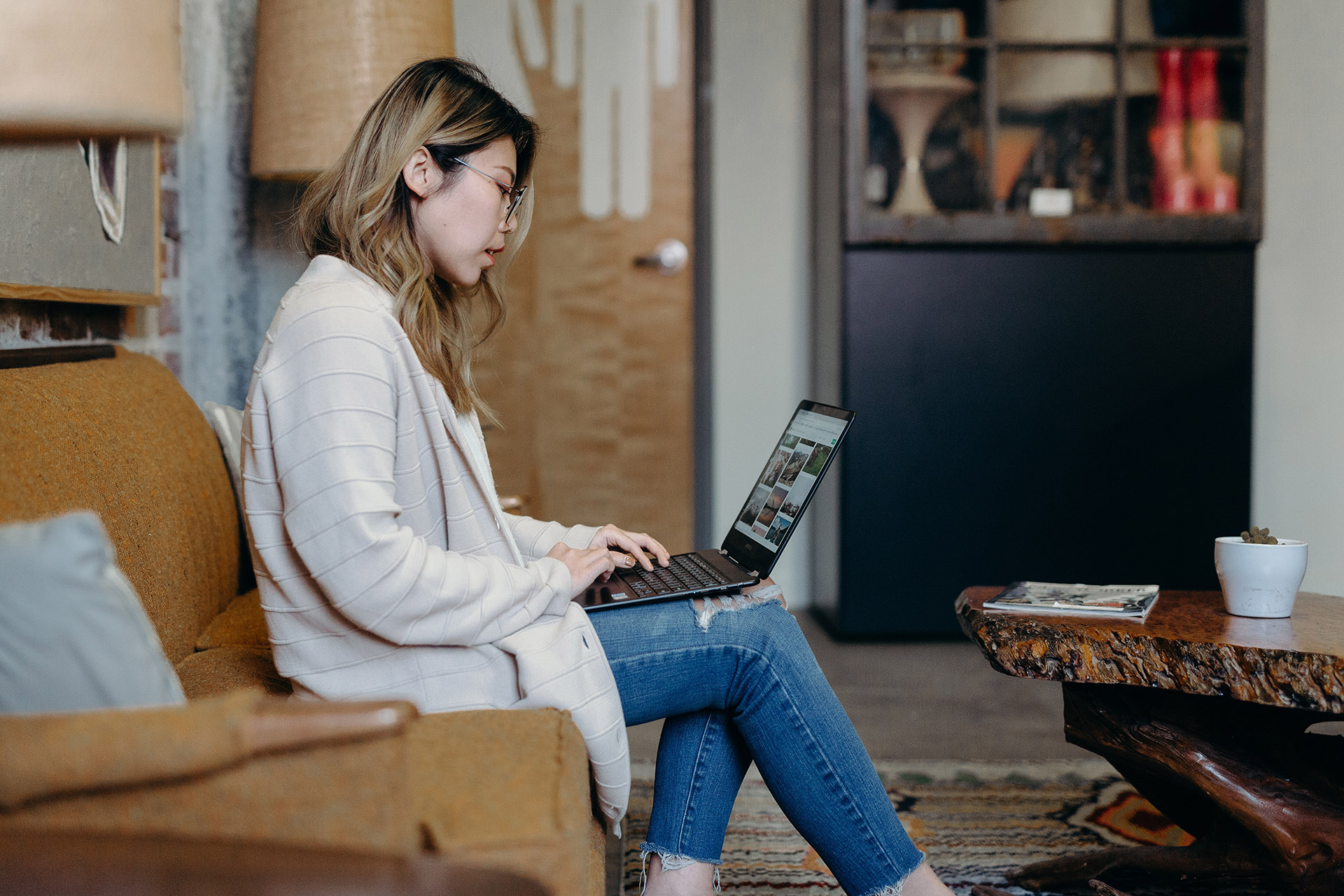 Photo of an Asian American woman sitting down using a laptop. This photo represents how you can access therapy with an Asian American therapist in San Ramon, CA to help support you in therapy and your cultural values.