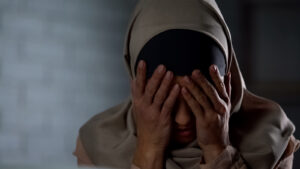 A woman wearing a hajib covers her face, representing the pain of past trauma that brainspotting therapy in San Ramon, CA can help you overcome. Learn more about brainspotting in California and other services by contacting a brainspotting therapist in San Ramon, CA today. 